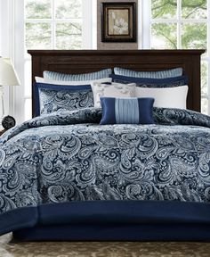 a blue and white comforter set with pillows