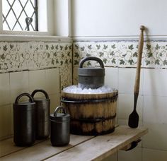 an old fashioned wooden barrel with ice in it on a shelf next to other items