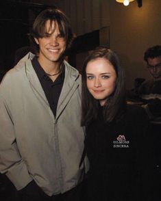 a man and woman standing next to each other