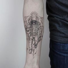 an astronaut tattoo on the arm