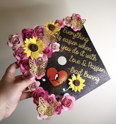 someone is holding up a graduation cap with flowers on it that says, everything is easier when you do it with love and passion