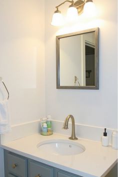 Bathroom vanity with framed mirror, new faucet, and organized countertop Remodel Hacks, Vanity Makeover