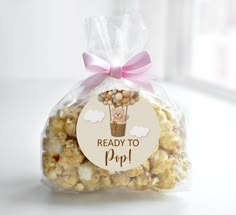 a bag filled with popcorn sitting on top of a table