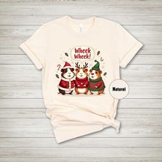 a t - shirt with two dogs wearing christmas sweaters and santa hats on it