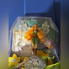 the tinker fairy doll is in its plastic box and it's yellow hair