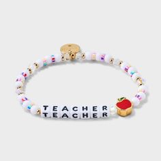 a white beaded bracelet with an apple and the words teacher on it