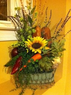 a basket filled with lots of different types of flowers