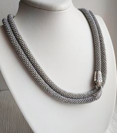 A handmade silver snake necklace from high-quality seed beads, cotton yarn with a snake head and tail clasps (jewelry hypoallergenic aluminum) is very flexible and comfortable to wear. * MEASUREMENTS: Necklace Length on photo: 40 inches (100 cm). Custom length available! Custom colors available! * This snake necklace could be lovely accessorize for your look every day, or special evening. This beaded necklace also is a perfect accessory, which can be worn formally or casually to add style to you Handmade Silver Snake Shape Necklace, Unique Silver Snake-shaped Necklace, Handmade Silver Snake Necklace, Handmade Silver Snake Jewelry, Handmade Silver Snake-shaped Jewelry, Silver Snake Necklace, Serpent Necklace, Snake Necklace Silver, Gothic Bracelet