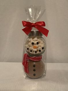 a snowman in a glass jar filled with candy