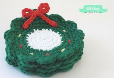 a crocheted christmas ornament with a red bow on it's top