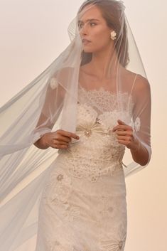 Drawing inspiration from 1920s glamour, this lace wedding dress features a sheer design layered with delicate lace and adorned with hand-placed floral embroidery that cascades down the train.   #weddinginspiration #weddingphotography #bridestobe #weddingday #vintageinspired #weddingaesthetic #weddinggown #graceloveslace 1920s Glamour, Lace Dresses