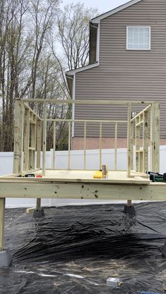 a wooden deck being built in front of a house