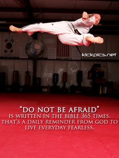 a man flying through the air while riding a kickbox in a gym with a quote on it