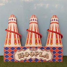 three circus tents with the word hoopia written on them in front of a blue wall