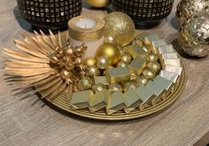 a table topped with gold and silver decorations