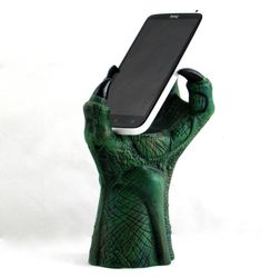 a cell phone is held up in the shape of a hand holding a tablet computer