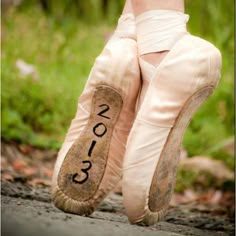 a ballerina's feet with the number 2013 written on them