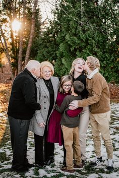 an extended family poses for a photo in the snow