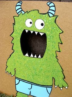 a cardboard box with a green monster on it's face and large, sharp teeth