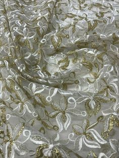 "Content: 100% polyester Organza embroidered lace mix with white and gold This fabric is beautiful and it is perfect for dresses, skit, tops, draping, and more Width: 45/47\" price per yard" Celebration Lace Fabric With Floral Embroidery, Elegant White Embroidered Fabric For Celebrations, Elegant Gold Lace Fabric, White Lace Embroidered Fabric For Festive Occasion, Festive White Lace Embroidered Fabric, White Lace For Spring Party, Gold Fitted Floral Embroidered Dupatta, Elegant White Embroidered Fabric For Summer, Festive Embroidered White Lace