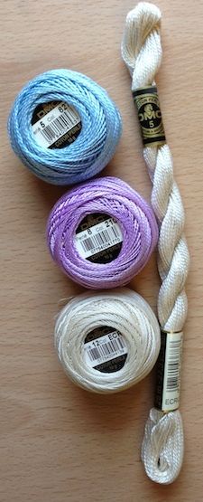 three spools of thread sitting next to each other