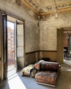 an empty living room with peeling paint on the walls