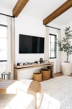 a large flat screen tv mounted to the side of a wall in a living room