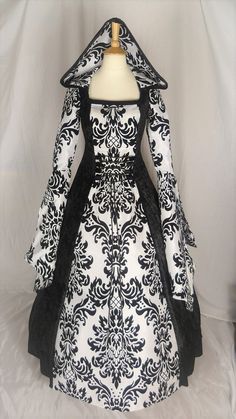 This listing is for a custom made dress, it will be made to the measurements you send me. Please send me your bust, waist and hip measurement, and please measure from the top of your shoulder to the floor with shoes on. It will be made with beautiful jet black crushed velvet and stunning white & black flocked taffeta. It has a corset style front and back with black lacing so you can adjust the dress to fit your body shape. Combined shipping on multiple items. If you purchase express shipping by courier please send me your phone number thank you. Fitted Black Gown With Boned Bodice, Black Fitted Gown With Boned Bodice, Fitted Gothic Ball Gown, Fitted Wedding Dress With Boned Bodice For Banquet, Fitted Medieval Dress For Evening Floor-length, Gothic Ball Gown With Fitted Bodice, Gothic Ball Gown For Wedding, Fitted Gothic Gown For Costume, Gothic Fitted Gown For Costume