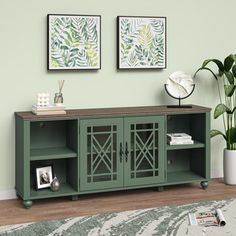 a living room scene with focus on the sideboard and two framed pictures above it