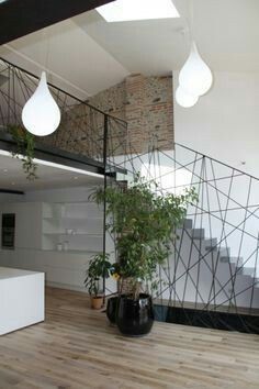 a living room filled with lots of furniture and decor on top of wooden flooring