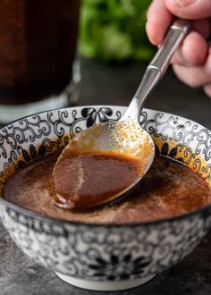 a spoon in a bowl filled with chocolate pudding