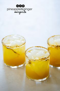 three glasses filled with drinks sitting on top of a table next to each other and the words pineapple ginger margarita