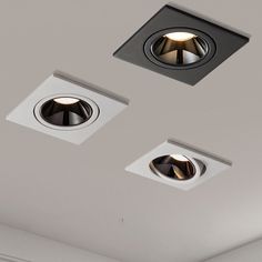 two recessed lights on the ceiling in a room with white walls and grey ceilings