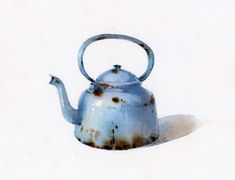 a blue teapot with rust on it sitting in the middle of a white floor