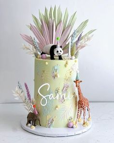 there is a cake decorated with animals and plants