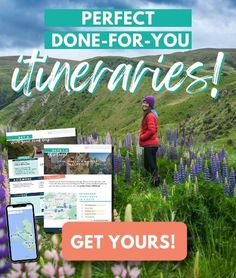 a woman standing on top of a lush green hillside next to purple wildflowers