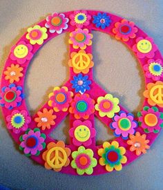 a peace sign made out of flowers and buttons