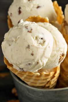 three ice cream cones in a metal bowl