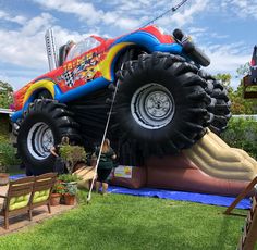 an inflatable monster truck is parked on the lawn