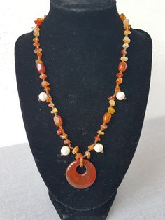 I only make one-offs!! Beautiful, handmade necklace with carnelian and cultured pearls, the highlight is the round carnelian pendant. Carnelian promotes courage, energy and a good mood. Physically, it should have a stimulating effect on the metabolism and circulation. Length: appr.  46 cm This article is finished and will be shipped within 1 working day. All items will be sent to you via a tracked or signed for delivery service. However, shipping times may vary as everything is shipped from Spai Bohemian Orange Agate Jewelry, Handmade Agate Spiritual Necklaces, Handmade Agate Spiritual Necklace, Round Carnelian Necklaces With Natural Stones, Bohemian Carnelian Beaded Necklace As Gift, Bohemian Carnelian Beaded Necklace For Gift, Handmade Agate Necklaces For Healing, Round Carnelian Gemstone Bead Necklaces, Round Carnelian Gemstone Beads Necklace