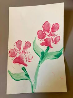 a piece of paper with some flowers painted on it