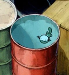 three buckets sitting next to each other on top of a wooden table with an animal drawn on the lid