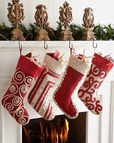 christmas stockings hanging from a mantel over a fireplace