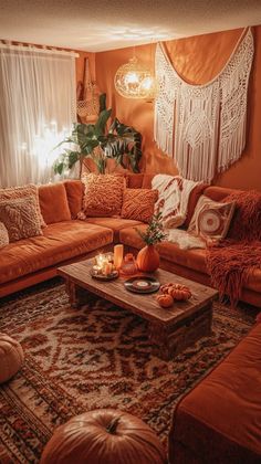 a living room filled with lots of orange couches and pillows on top of a rug