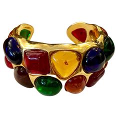 1980s Chanel gold toned cuff bangle adorned with 17 multicolored Gripoix. Stamped 26 made in France. Circumference measures approximately 16 cm Width 3.3 cm Opening 1.6 cm. Comes with dust bag and box. Condition: Minor signs of wear. Generally in very good condition Chanel Vintage Jewelry, 1980s Chanel, Chanel Necklaces, Gold Vintage Jewelry, 1970s Jewelry, Gold Bracelets, Gold Box, Retro Jewelry, Chanel Jewelry