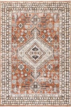 an orange and black area rug with geometric designs on the bottom, in front of a white