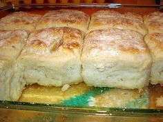 a pan filled with rolls covered in powdered sugar sitting on top of a counter