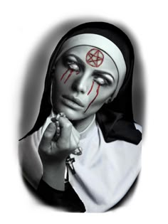 a woman with makeup painted on her face and holding a cross in one hand while wearing a nun's headdress