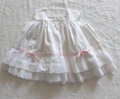 "FRENCH VINTAGE 50's, stunning white summer dress, pure cotton fabric, French lace ruffles and pink satin ribbon, buttoned at the back ( mother of pearl buttons ).  Estimated size 1 year Length \" - Underarams ( taken flat ) \" New old stock ( washed once ) I always refund overcharged shipping from 1 Euros overpaid ! Thank you for your visit" White Cotton Dress With Attached Cancan, Summer Cotton Lace Dresses With Ruffles, Summer Wedding Dress With Eyelet Details, White Cotton Dress With Broderie Anglaise, White Cotton Lace Patchwork Dress, White Cotton Petticoat With Attached Cancan, White Cotton Dress With Lace Trim, Summer Dress With Cotton Lace Collar, White Cotton Summer Petticoat