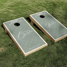 two personalized cornhole game boards on the grass